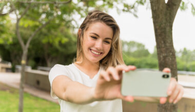 girl takes photo on smartphone
